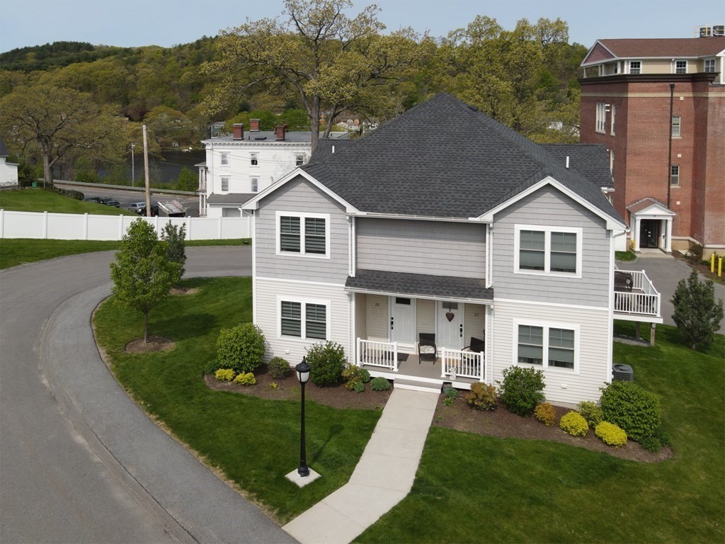 25 Eagle Nest Road, Unit 25 Clinton, MA 01510 - Photo 3 of 38 a front view of a house with a yard table and chairs