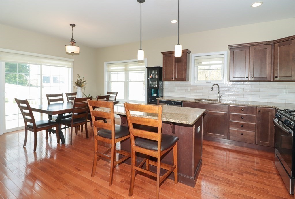 25 Eagle Nest Road, Unit 25 Clinton, MA 01510 - Photo 6 of 38 a dining table with chairs and wooden floor