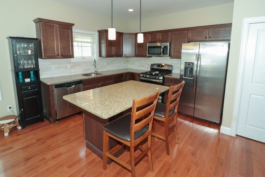 25 Eagle Nest Road, Unit 25 Clinton, MA 01510 - Photo 8 of 38 a kitchen with stainless steel appliances granite countertop a sink a stove a refrigerator and a microwave