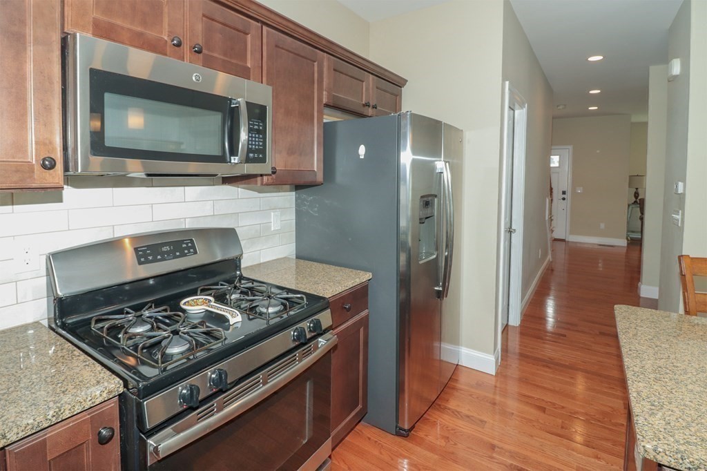 25 Eagle Nest Road, Unit 25 Clinton, MA 01510 - Photo 9 of 38 a kitchen with stainless steel appliances granite countertop a stove and a microwave
