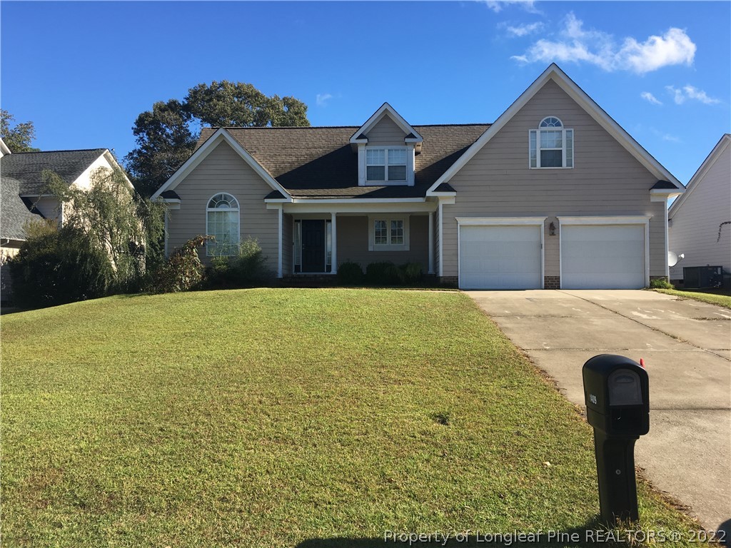 1409 Blue Ribbon Lane Hope Mills, NC 28348 - Photo 1 of 19 a front view of a house with yard
