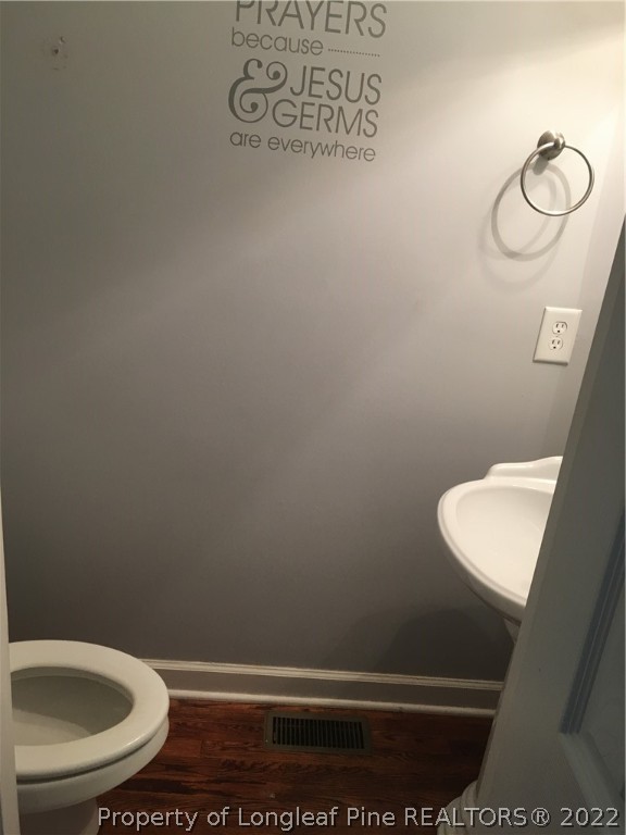 1409 Blue Ribbon Lane Hope Mills, NC 28348 - Photo 12 of 19 a bathroom with a toilet and a sink