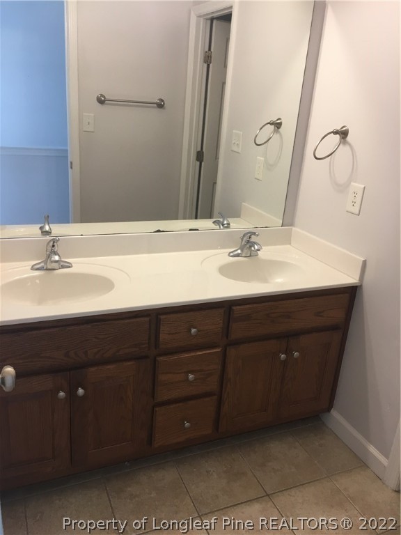 1409 Blue Ribbon Lane Hope Mills, NC 28348 - Photo 16 of 19 a bathroom with a sink and a mirror