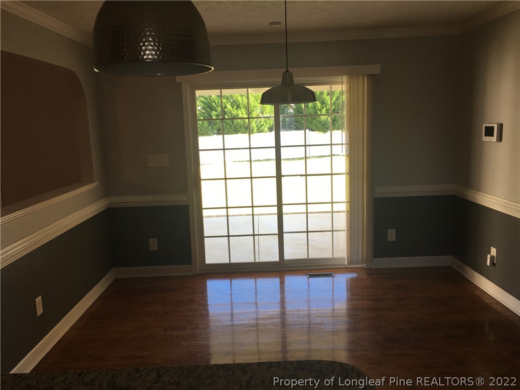 1409 Blue Ribbon Lane Hope Mills, NC 28348 - Photo 7 of 19 a view of an empty room with wooden floor and a window