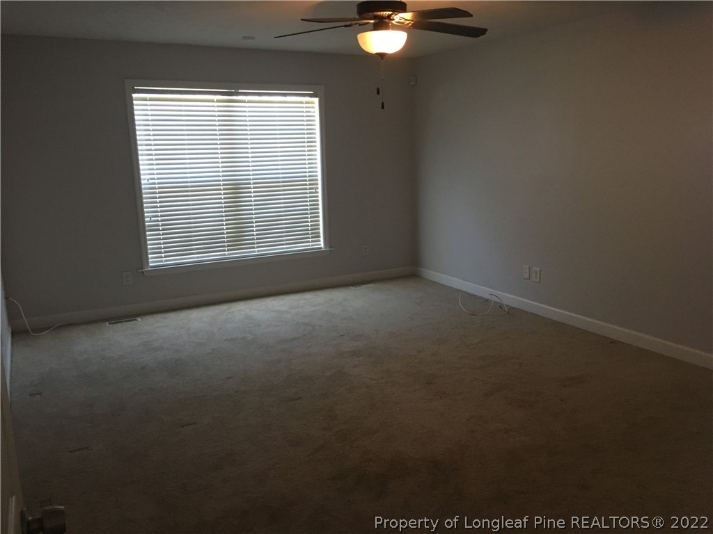 1409 Blue Ribbon Lane Hope Mills, NC 28348 - Photo 8 of 19 a view of a livingroom with an empty space and a window