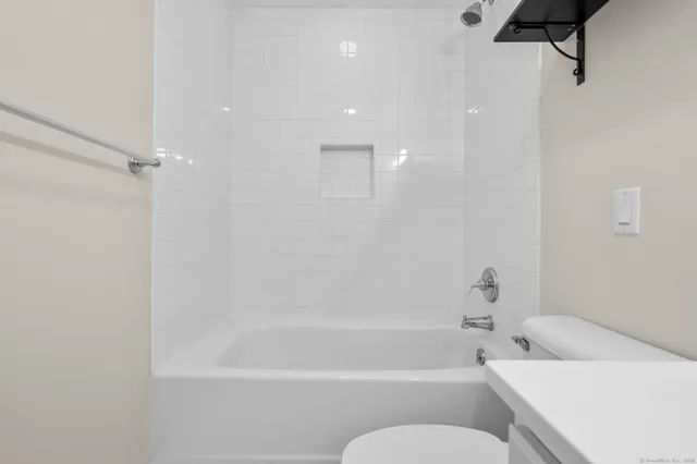 a bathroom with a bathtub and shower
