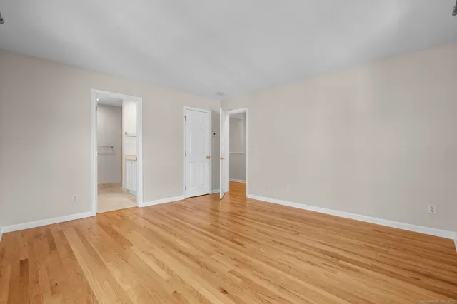 a view of an empty room and wooden floor