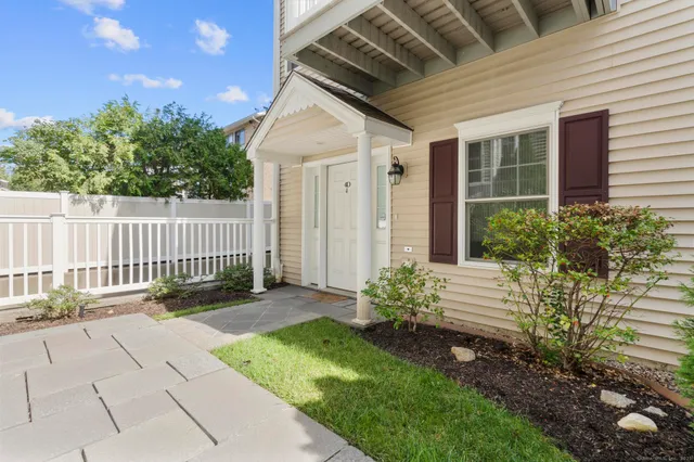 a view of a house with a yard and a garden