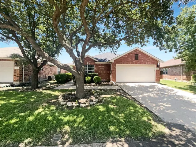 a front view of a house with a yard garage and outdoor seating