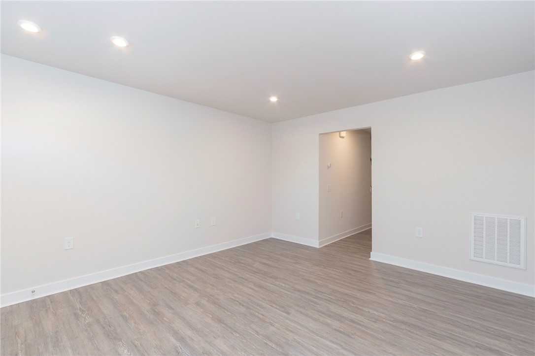 233 Scenic Road Anderson, SC 29621 - Photo 5 of 50 Recessed lighting illuminates this versatile room with durable laminate flooring.