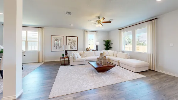 a living room with fireplace furniture and a large window