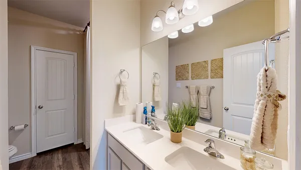 a bathroom with a sink vanity granite and a mirror