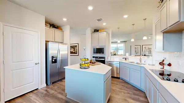 a large kitchen with stainless steel appliances lots of counter space and refrigerator