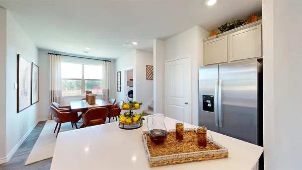a kitchen with sink and refrigerator