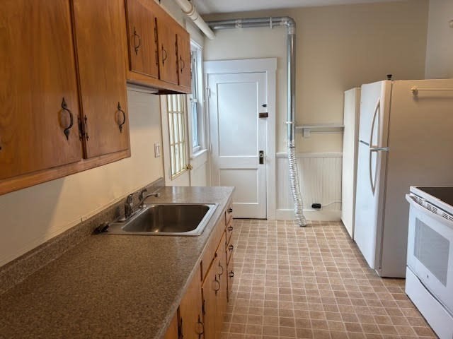 1 Windsor Avenue, Unit 1 Acton, MA 01720 - Photo 3 of 14 a kitchen with a refrigerator and a sink