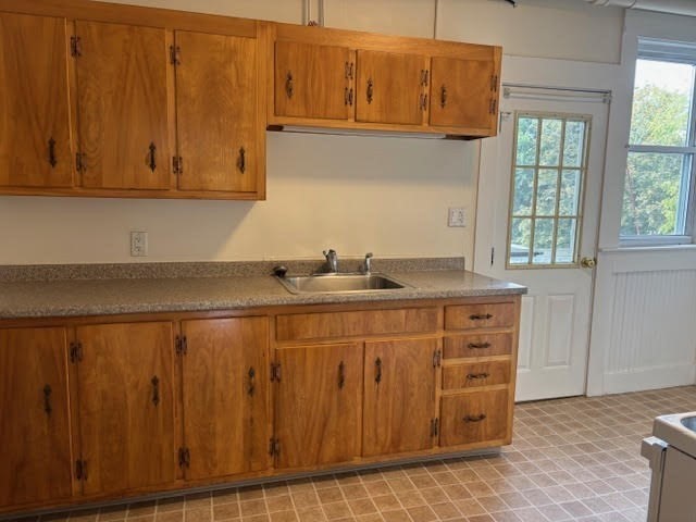 1 Windsor Avenue, Unit 1 Acton, MA 01720 - Photo 4 of 14 a kitchen with granite countertop white cabinets and sink