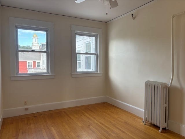 1 Windsor Avenue, Unit 1 Acton, MA 01720 - Photo 10 of 14 a view of an empty room with wooden floor and a window