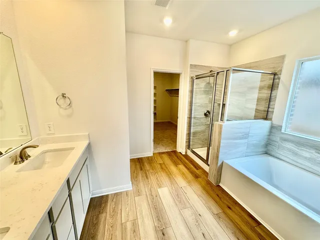 a spacious bathroom with a tub and a sink