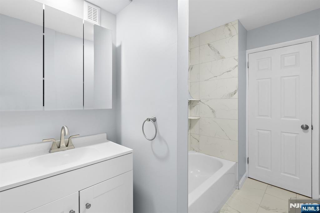 736 2nd Street, Unit 1 Secaucus, NJ 07094 - Photo 12 of 21 a bathroom with a sink a toilet and shower