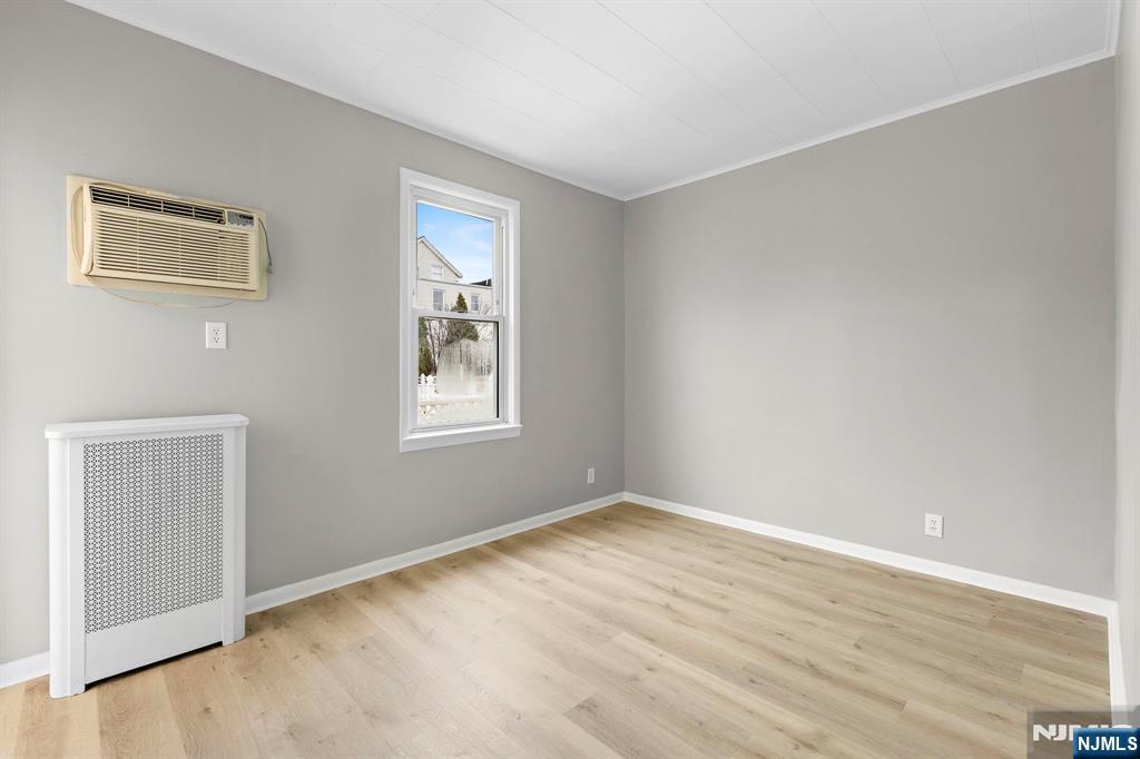 736 2nd Street, Unit 1 Secaucus, NJ 07094 - Photo 13 of 21 a view of an empty room with wooden floor and a window