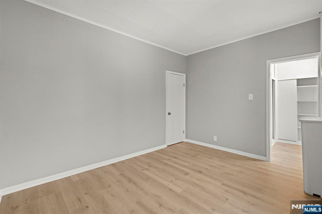 736 2nd Street, Unit 1 Secaucus, NJ 07094 - Photo 16 of 21 a view of an empty room with wooden floor and a window