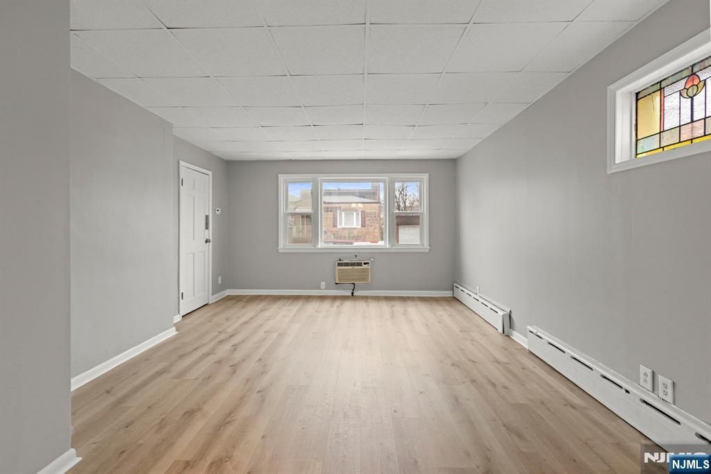 736 2nd Street, Unit 1 Secaucus, NJ 07094 - Photo 5 of 21 an empty room with wooden floor and windows