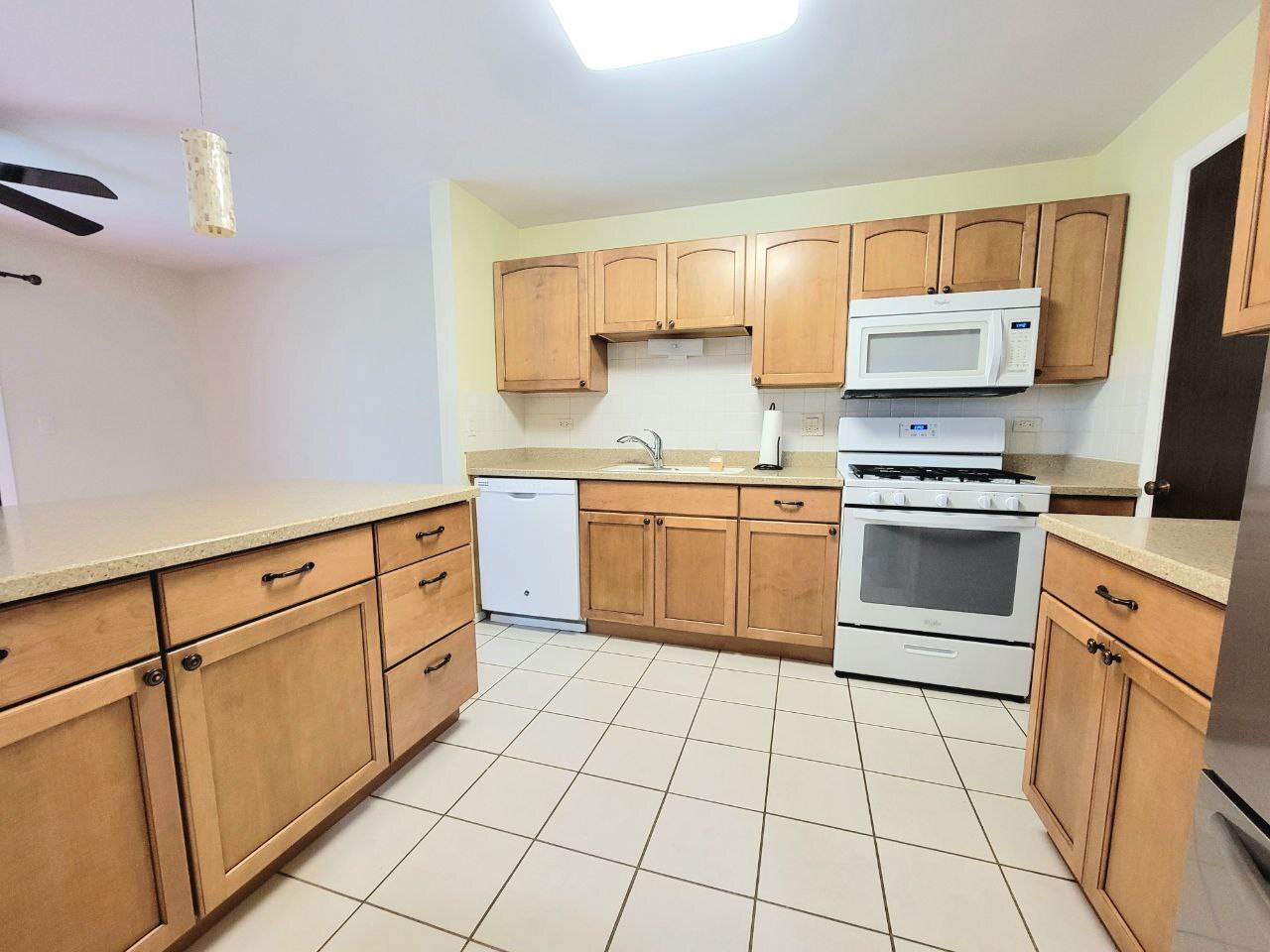 4730 Calvert Drive, Unit B1 Rolling Meadows, IL 60008 - Photo 11 of 23 a kitchen with white cabinets appliances and a sink