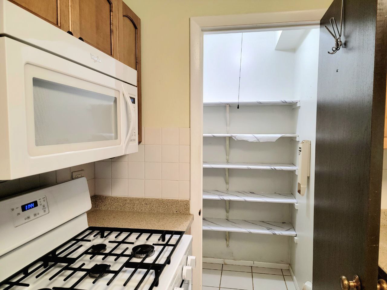 4730 Calvert Drive, Unit B1 Rolling Meadows, IL 60008 - Photo 13 of 23 a kitchen with a refrigerator a stove and white cabinets