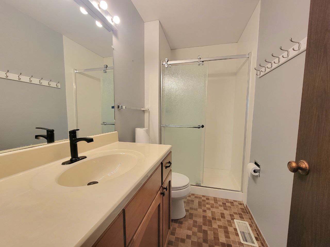 4730 Calvert Drive, Unit B1 Rolling Meadows, IL 60008 - Photo 17 of 23 a bathroom with a sink a mirror and a shower
