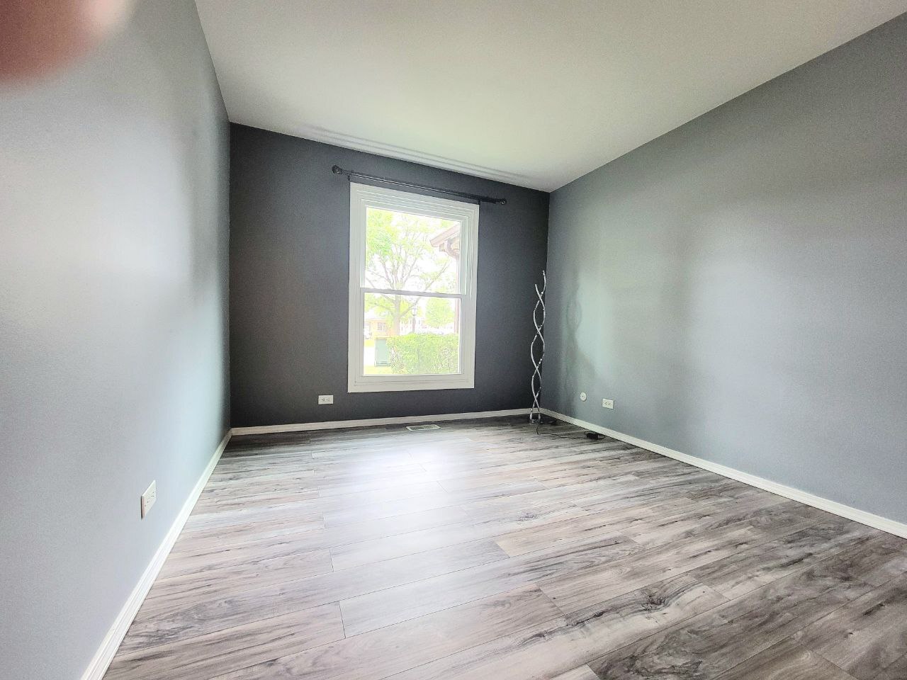 4730 Calvert Drive, Unit B1 Rolling Meadows, IL 60008 - Photo 19 of 23 an empty room with wooden floor and windows