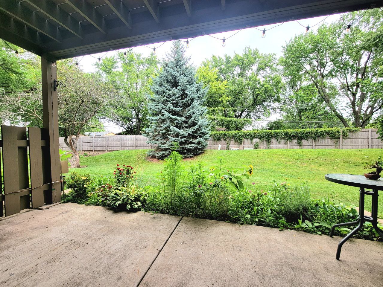 4730 Calvert Drive, Unit B1 Rolling Meadows, IL 60008 - Photo 4 of 23 a view of a garden with chair and floor to ceiling window