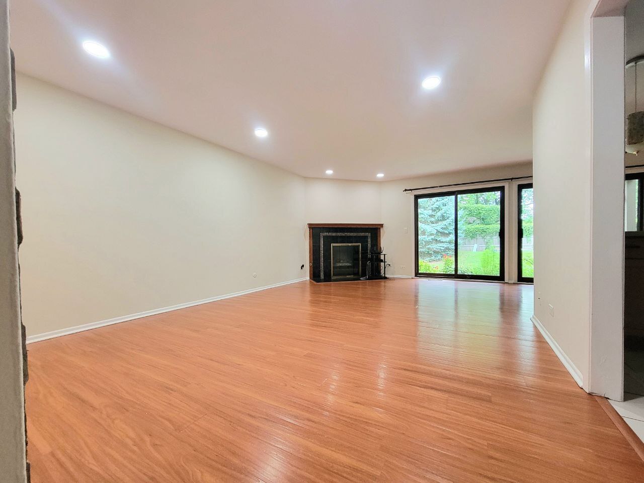 4730 Calvert Drive, Unit B1 Rolling Meadows, IL 60008 - Photo 6 of 23 a view of an empty room with wooden floor and a window