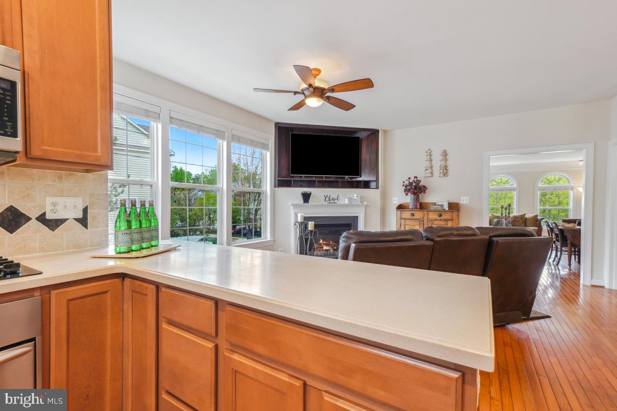 4091 River Forth Drive Fairfax, VA 22030 - Photo 13 of 32 a living room with furniture a flat screen tv and a fireplace