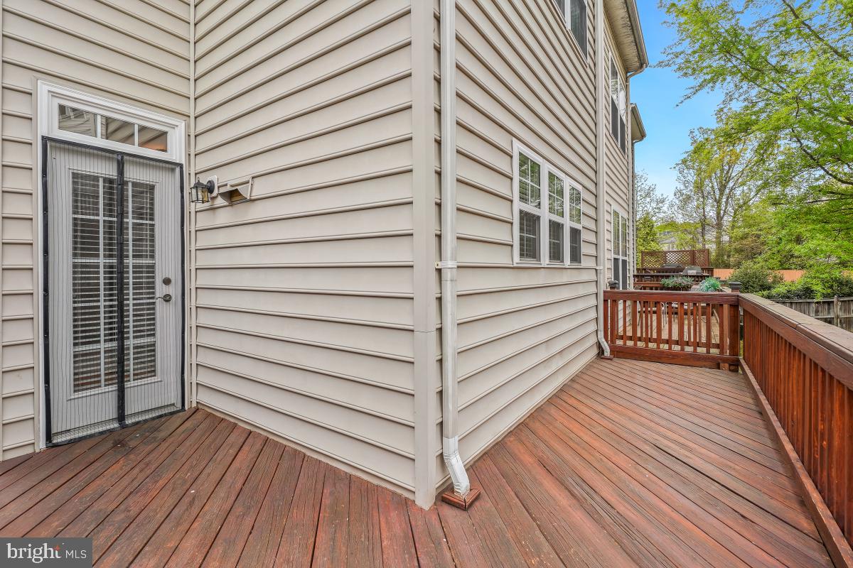 4091 River Forth Drive Fairfax, VA 22030 - Photo 14 of 32 a view of a balcony with wooden floor and fence and a floor to ceiling window