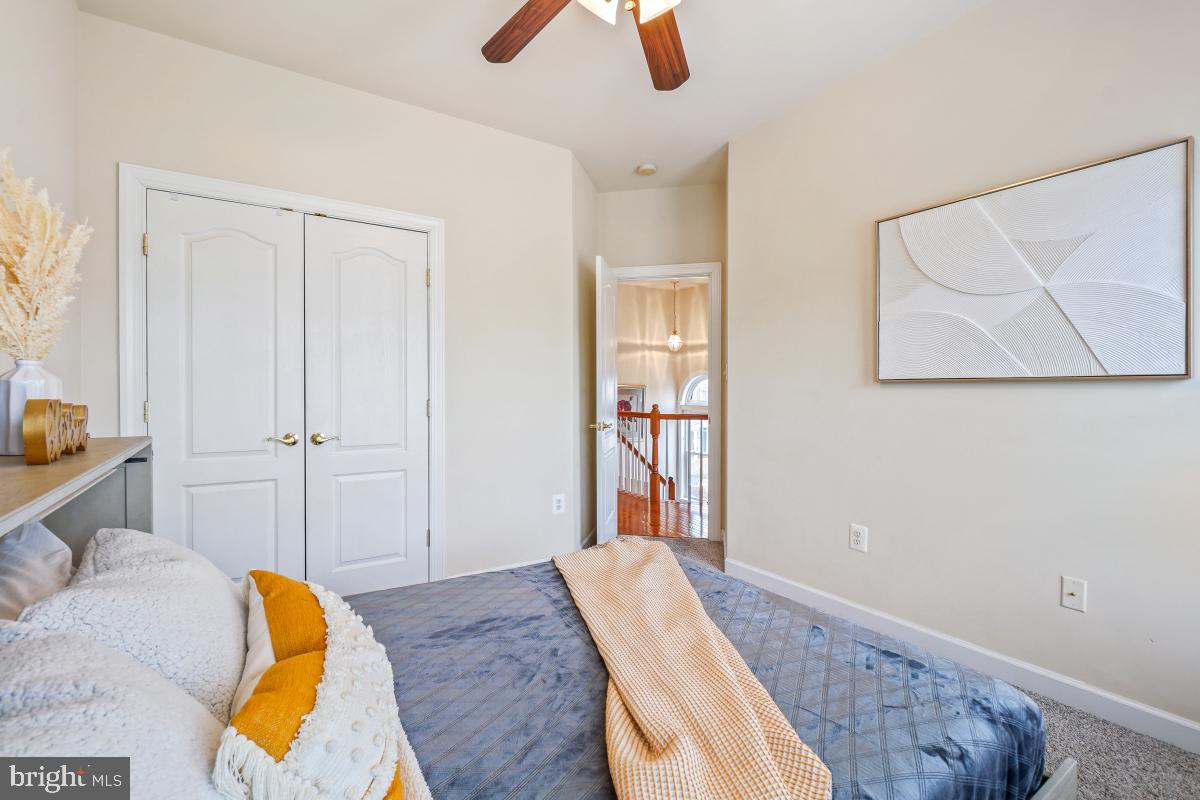 4091 River Forth Drive Fairfax, VA 22030 - Photo 18 of 32 a bedroom with a bed and painting on the wall