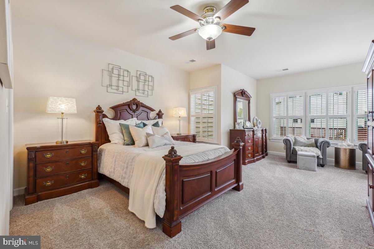4091 River Forth Drive Fairfax, VA 22030 - Photo 22 of 32 a spacious bedroom with a bed and a chandelier