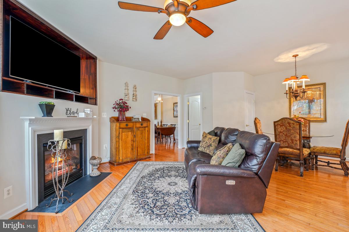 4091 River Forth Drive Fairfax, VA 22030 - Photo 10 of 32 a living room with furniture a fireplace and a flat screen tv