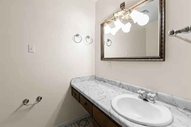 a bathroom with a sink and mirror