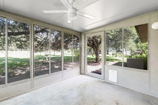 a view of a room with large windows and view of an outdoor space