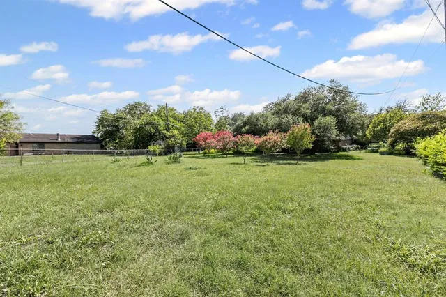 a view of a garden with a building in the background