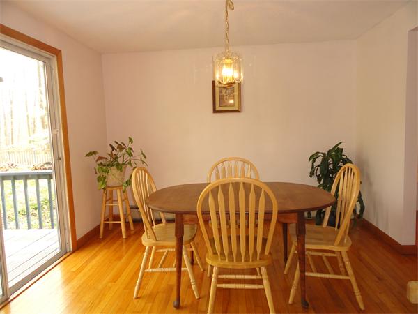 115 Leverett Road Amherst, MA 01002 - Photo 4 of 15 a view of a dining room with furniture a chandelier and wooden floor