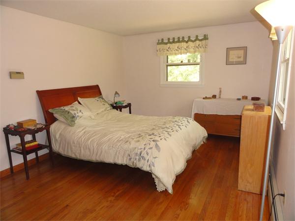 115 Leverett Road Amherst, MA 01002 - Photo 8 of 15 a bedroom with a bed and wooden floor