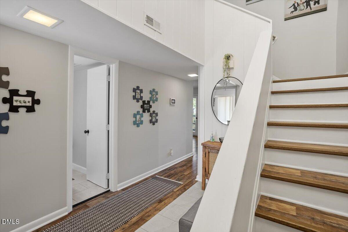 5045 Tall Pines Court Raleigh, NC 27609 - Photo 4 of 37 a view of a hallway with wooden floor and entryway