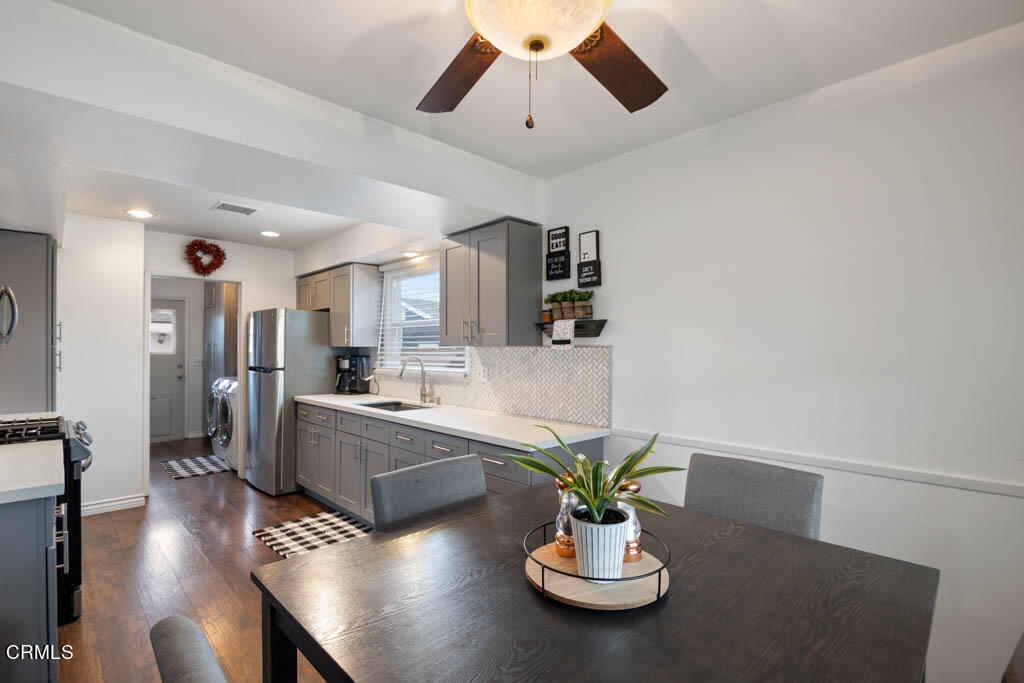 9195 Harvard Street Rancho Cucamonga, CA 91730 - Photo 17 of 37 a living room with furniture kitchen island dining table and wooden floor