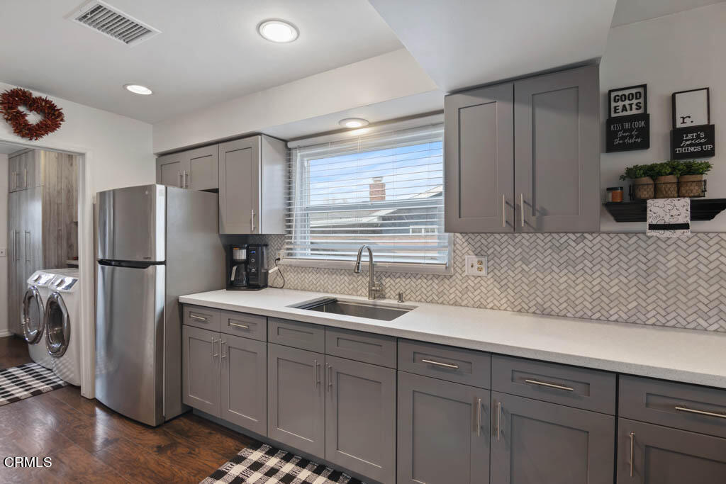 9195 Harvard Street Rancho Cucamonga, CA 91730 - Photo 18 of 37 a kitchen with a sink and refrigerator