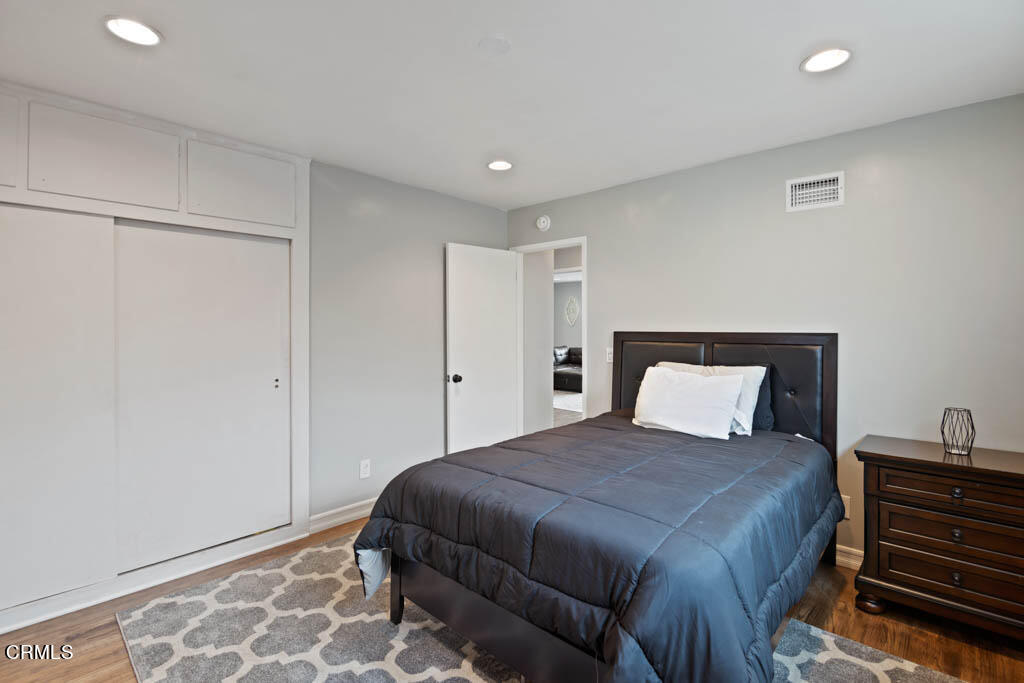 9195 Harvard Street Rancho Cucamonga, CA 91730 - Photo 20 of 37 a large bedroom with a bed and wooden floor