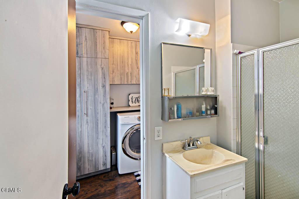 9195 Harvard Street Rancho Cucamonga, CA 91730 - Photo 26 of 37 a bathroom with a sink a washer and dryer