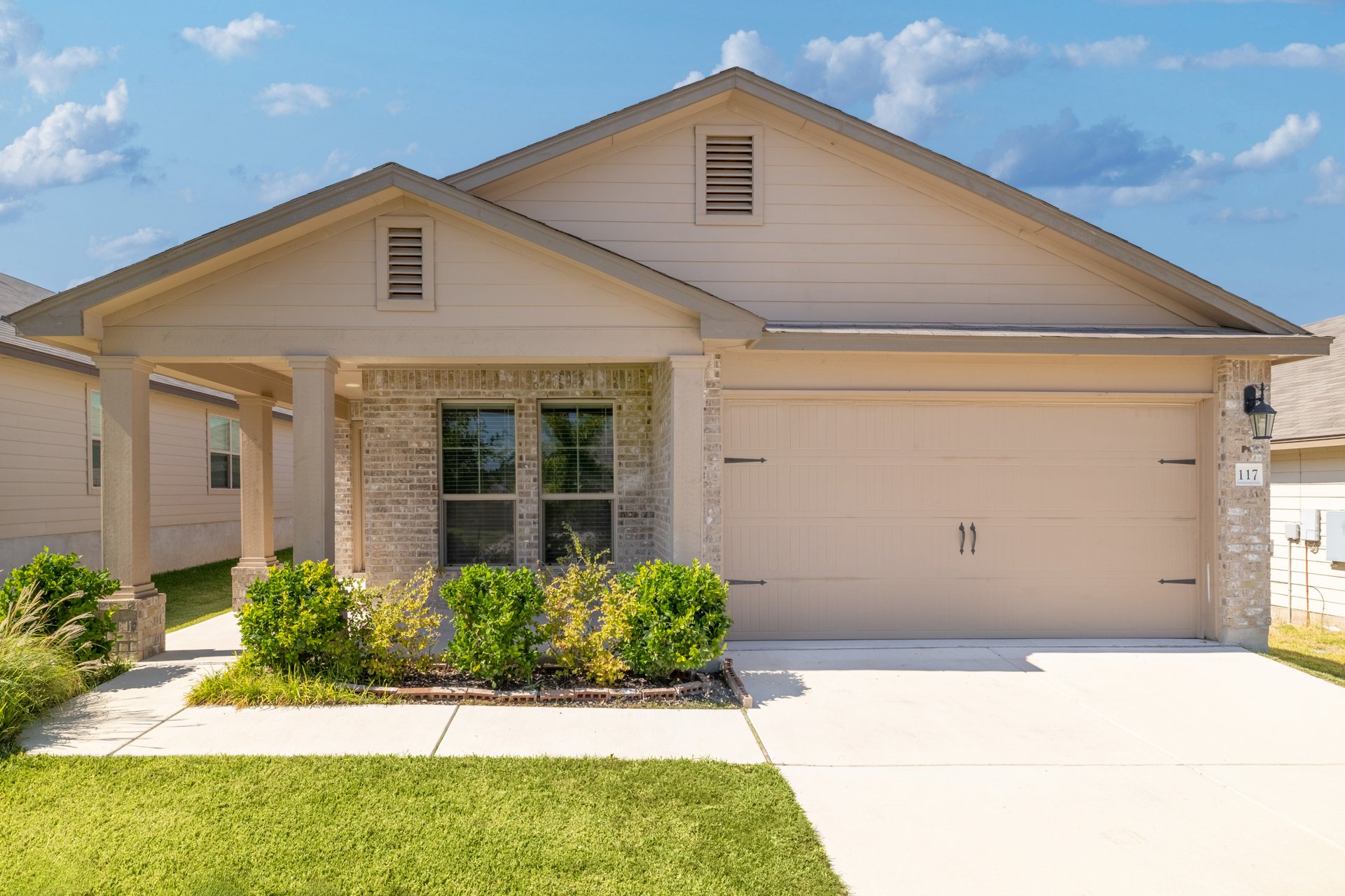 a front view of a house with a yard
