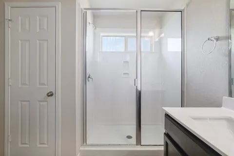 a bathroom with a shower and a sink