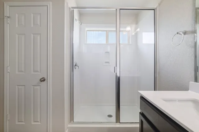 a bathroom with a shower and a sink